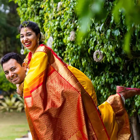 Anushree Gowri, San Jose, smiling in a yellow and red silk saree in a garden